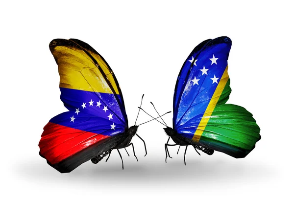 Papillons avec drapeaux du Venezuela et des Îles Salomon sur les ailes — Photo