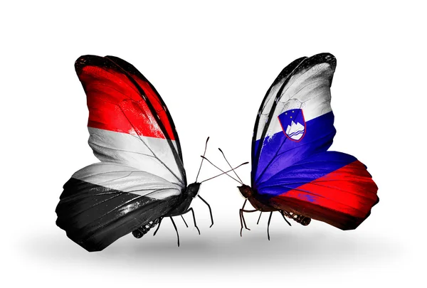 Butterflies with Yemen and Slovenia flags on wings — Stock Photo, Image