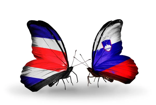 Kosta Rika ve Slovenya bayrakları kanatlar üzerinde kelebekler — Stok fotoğraf
