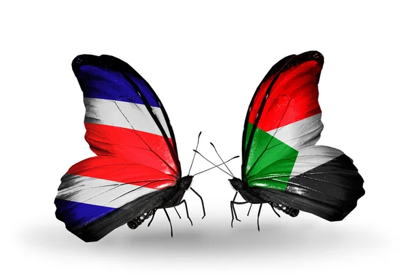 Borboletas com bandeiras da Costa Rica e Sudão em asas — Fotografia de Stock