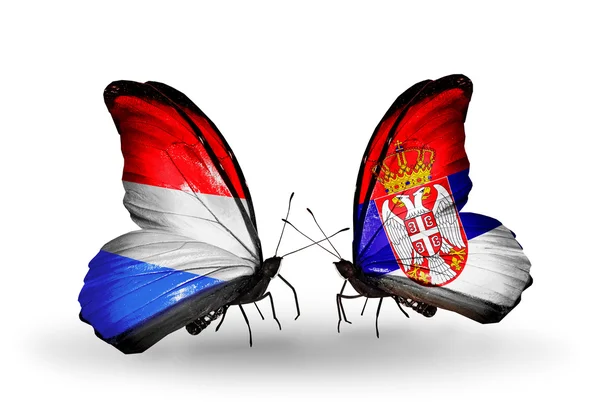 Butterflies with Luxembourg and Serbia  flags on wings — Stock Photo, Image