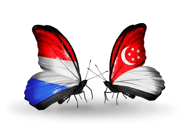 Papillons avec des drapeaux de luxembourg et à Singapour sur les ailes — Φωτογραφία Αρχείου