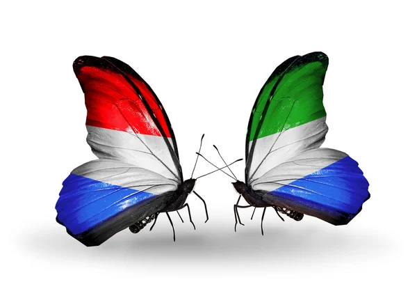 蝴蝶翅膀上的卢森堡和塞拉利昂标志 — 图库照片