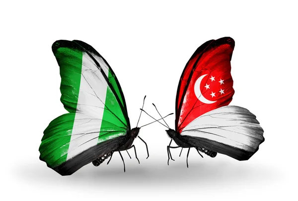 Butterflies with Nigeria and  Singapore flags on wings — Stock Photo, Image