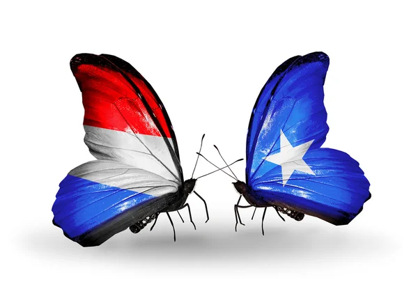 Motyle z flagi Luksemburga i Somalii na skrzydłach — Zdjęcie stockowe