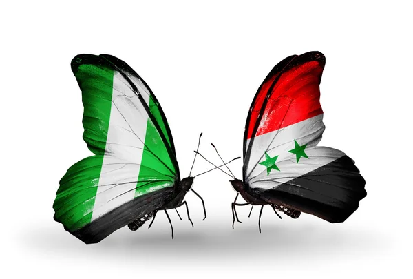 Butterflies with  Nigeria and Syria flags on wings — Stock Photo, Image