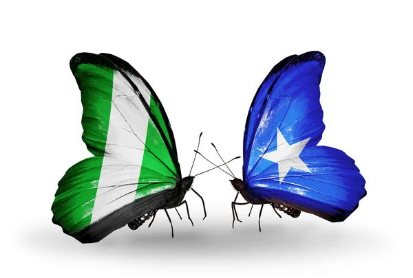Mariposas con banderas de Nigeria y Somalia en alas — Foto de Stock