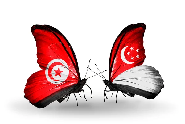 Butterflies with Tunisia and Singapore flags on wings — Stock Photo, Image