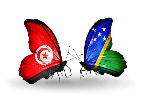Farfalle con bandiere Tunisia e Isole Salomone sulle ali — Foto Stock