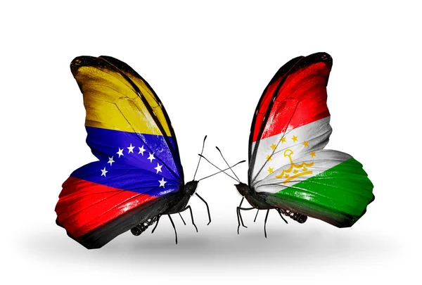 Farfalle con bandiere Venezuela e Tagikistan sulle ali — Foto Stock