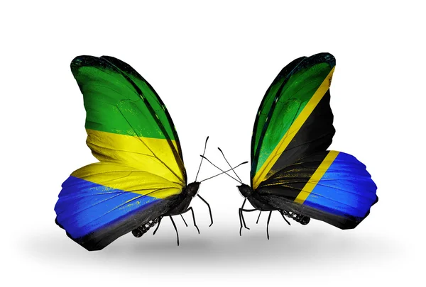 Vlinders met gabon en tanzania vlaggen op vleugels — Stockfoto