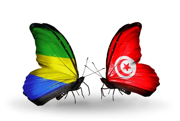 Butterflies with Gabon and Tunisia flags on wings — Stock Photo, Image