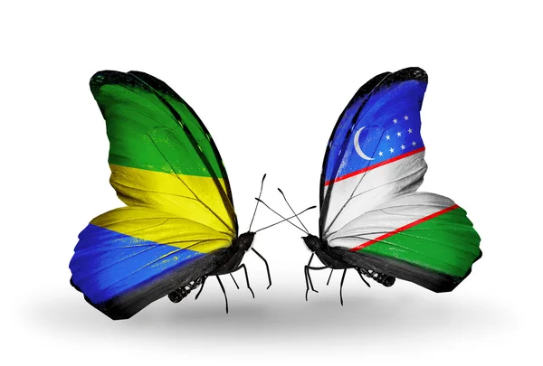 Butterflies with Gabon and Uzbekistan flags on wings — Stock Photo, Image