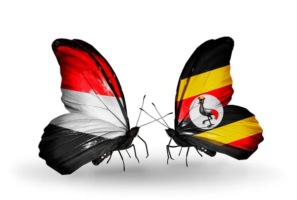 Vlinders met Jemen en Oeganda vlaggen op vleugels — Stockfoto