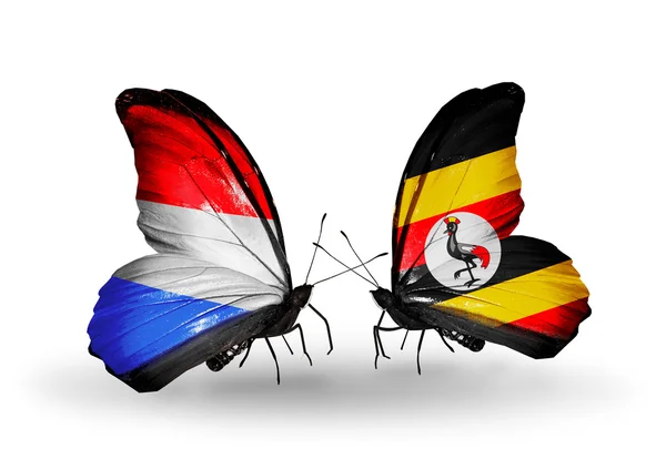 Vlinders met Luxemburg en Oeganda vlaggen op vleugels — Stockfoto