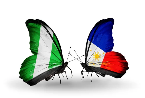 Fjärilar med nigeria och Filippinerna flaggor på vingar — Stockfoto