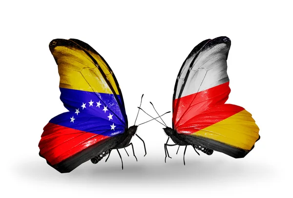 Schmetterlinge mit venezuela- und südossetischen Flaggen auf Flügeln — Stockfoto