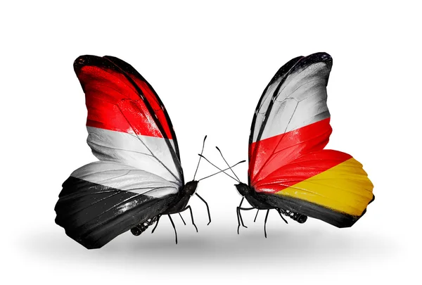 Butterflies with Yemen and South Ossetia flags on wings — Stock Photo, Image