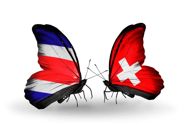 Motýli s costa rica a Švýcarsko vlajek na křídlech — Stock fotografie