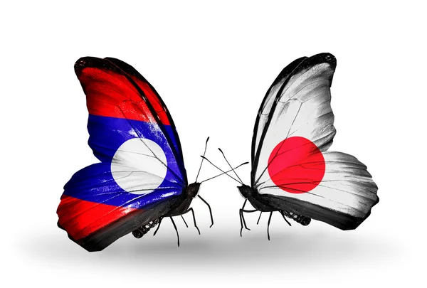 Vlinders met laos en japan vlaggen op vleugels — Stockfoto