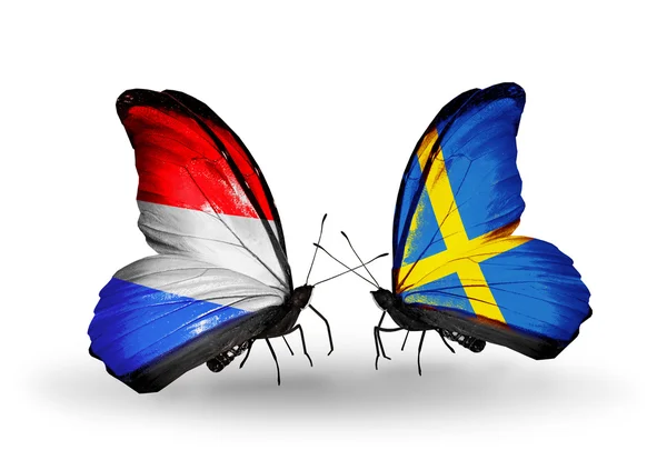 Motyle z flagi Luksemburga i Szwecji na skrzydłach — Zdjęcie stockowe