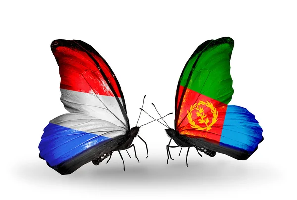 Butterflies with Luxembourg and Eritrea flags on wings — Stock Photo, Image