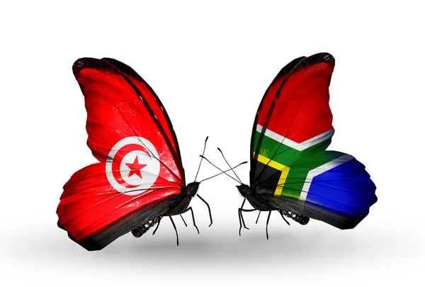 Бабочки с флагами Туниса и ЮАР на крыльях — стоковое фото