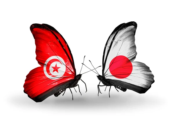 Fjärilar med Tunisien och japan flaggor på vingar — Stockfoto