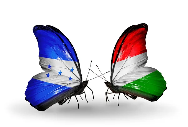 Kelebek kanatları üzerinde Macaristan ve honduras bayraklı — Stok fotoğraf