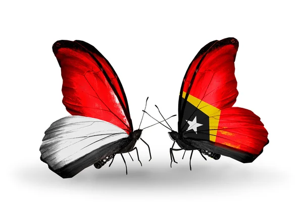 Butterflies with Monaco, Indonesia and East Timor flags on wings — Stock Photo, Image