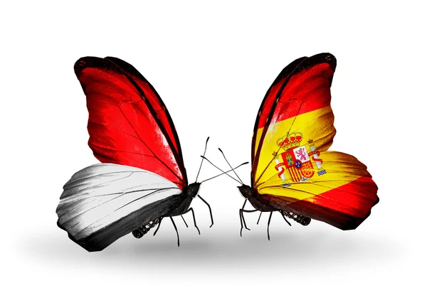 Borboletas com Mônaco, Indonésia e Espanha bandeiras em asas — Fotografia de Stock