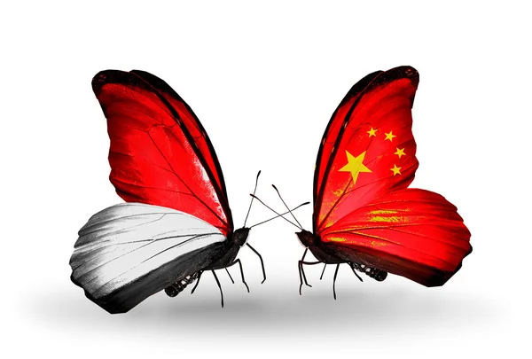 Vlinders met monaco, Indonesië en china vlaggen op vleugels — Stockfoto