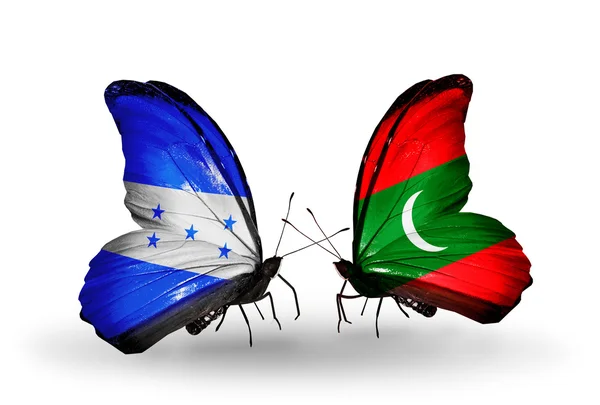 Vlinders met honduras en Maldiven vlaggen op vleugels — Stockfoto