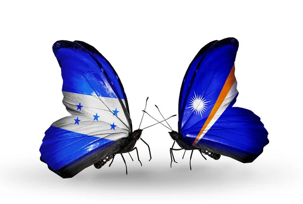 Motyle z Hondurasu i Wyspy Marshalla flagi na skrzydłach — Zdjęcie stockowe