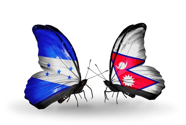 Mariposas con banderas de Honduras y Nepal en alas — Foto de Stock