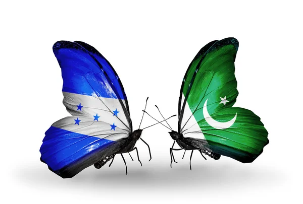 Vlinders met honduras en pakistan vlaggen op vleugels — Stockfoto