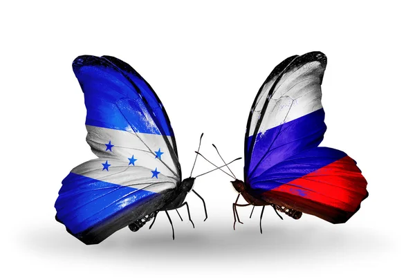 Mariposas con banderas de Honduras y Rusia en alas — Foto de Stock