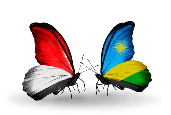 Butterflies with Monaco, Indonesia and Rwanda flags on wings — Stock Photo, Image