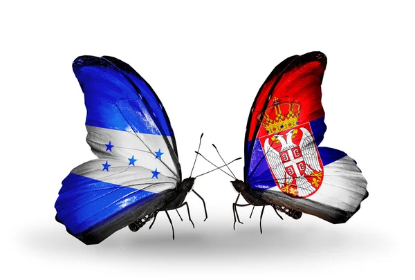 Papillons avec drapeaux Honduras et Serbie sur les ailes — Photo