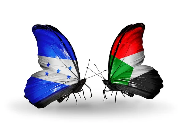 Бабочки с флагами Гондураса и Судана на крыльях — стоковое фото