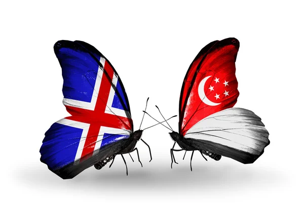 Vlinders met IJsland en singapore vlaggen op vleugels — Stockfoto