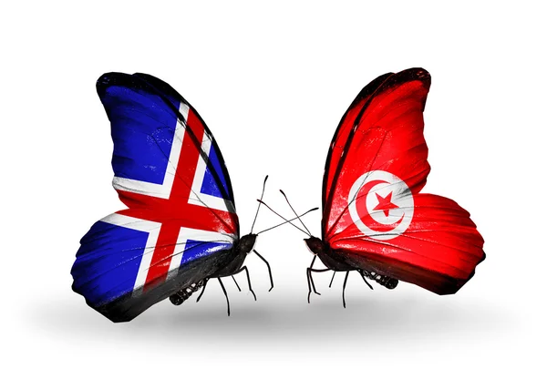 Kelebek kanatları üzerinde İzlanda ve Tunus bayraklı — Stok fotoğraf