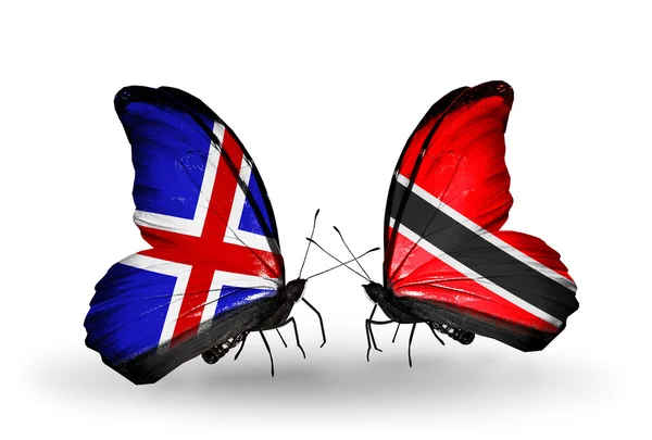 Schmetterlinge mit Island- und Trinida- und Tobago-Flaggen auf Flügeln — Stockfoto