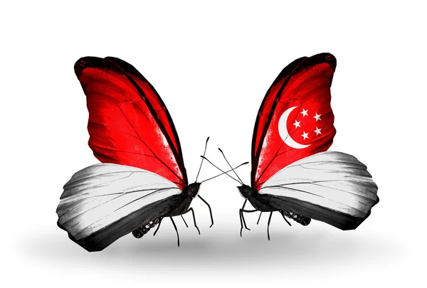 Butterflies with Monaco, Indonesia and Singapore flags on wings — Stock Photo, Image