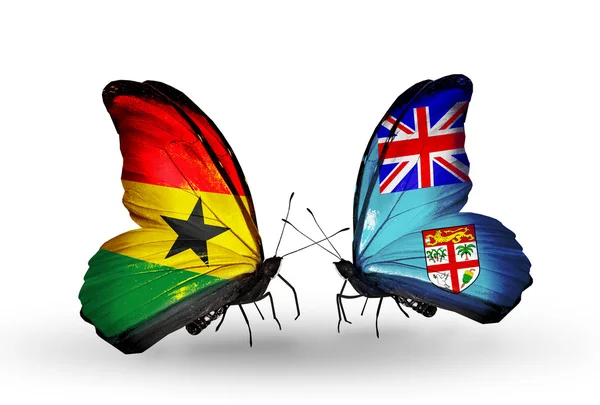 Mariposas con banderas de Ghana y Fiyi en alas — Foto de Stock