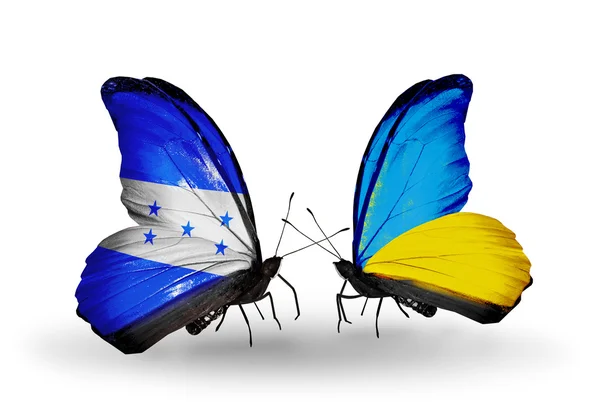 Mariposas con banderas de Honduras y Ucrania en alas — Foto de Stock