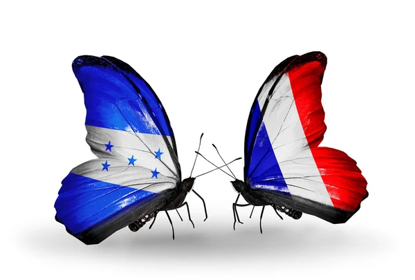 Kelebek kanatları üzerinde honduras ve Fransa bayraklı — Stok fotoğraf