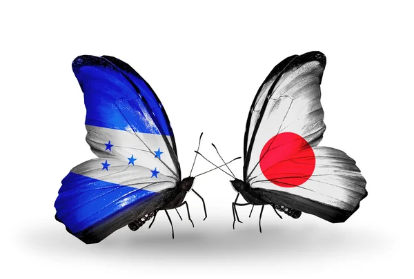 Papillons avec drapeaux Honduras et Japon sur les ailes — Photo