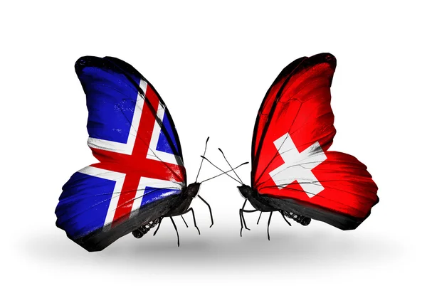 Butterflies with Iceland and Switzerland flags on wings — Stock Photo, Image
