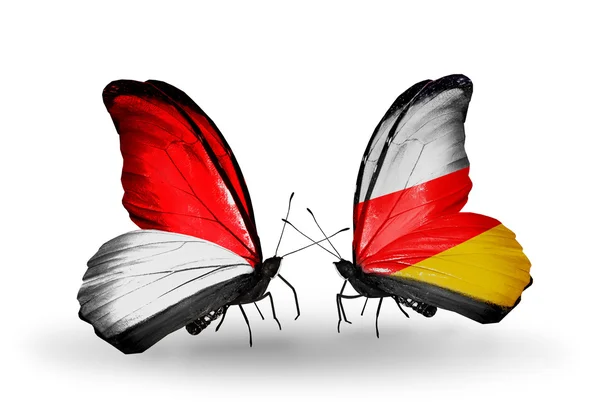 Motýli s Monako, Indonésie a Jižní Osetie vlajek na křídlech — Stock fotografie